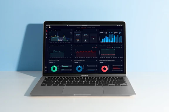 Laptop screen displaying the COROS Training Hub dashboard with training metrics and charts.