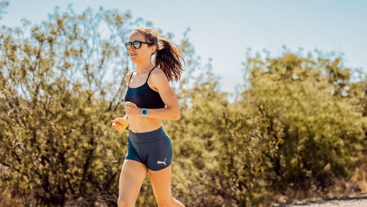 A close-up image of molly seidel running with a COROS PACE 2 Molly Edition watch.