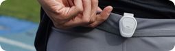 A close-up view of the COROS POD 2 being clipped on the back of the waistband.